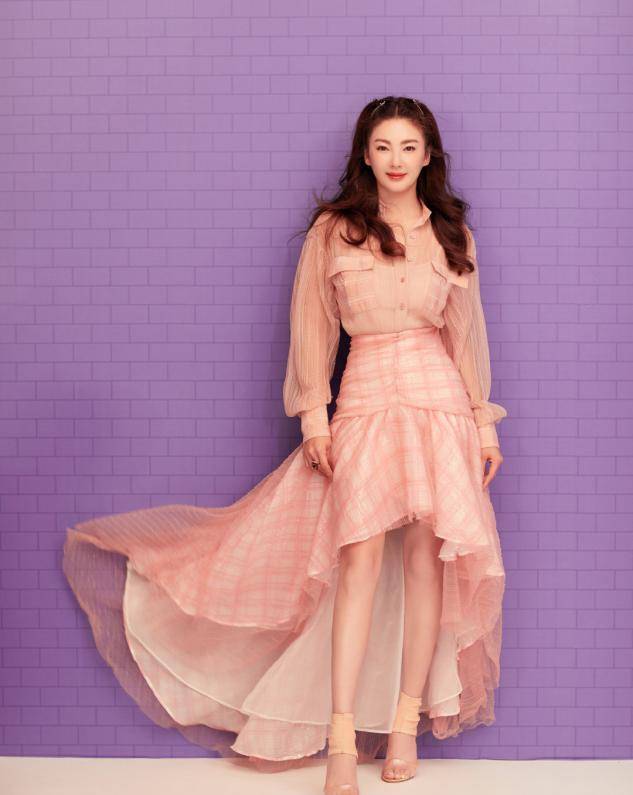 一身烟粉色的华丽长裙,一头简单清爽的微卷头发,没有周围的搭配